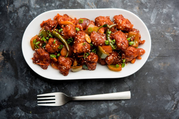 istock Indian Chilli Chicken dry, served in a plate over moody background. Selective focus 1072952894