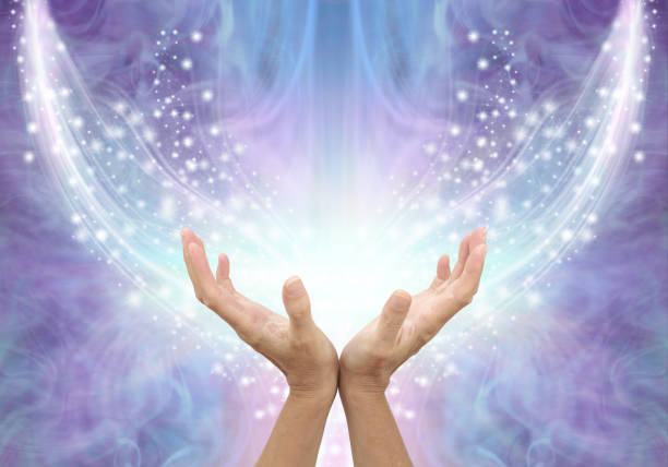 Bathing in Beautiful Healing Resonance female cupped hands reaching up into an arc of shimmering sparkles on a glowing purple blue ethereal energy formation background with copy space reiki photos stock pictures, royalty-free photos & images