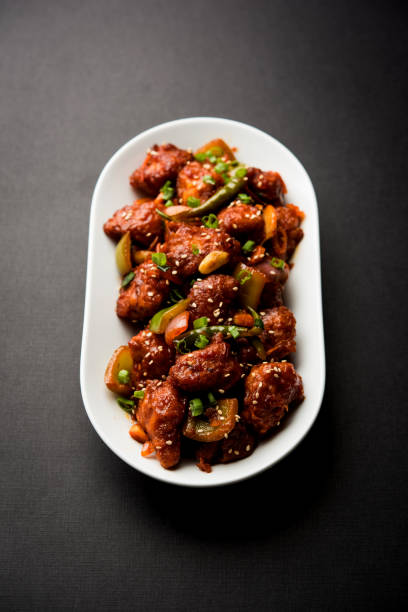 istock Indian Chilli Chicken dry, served in a plate over moody background. Selective focus 1072953476