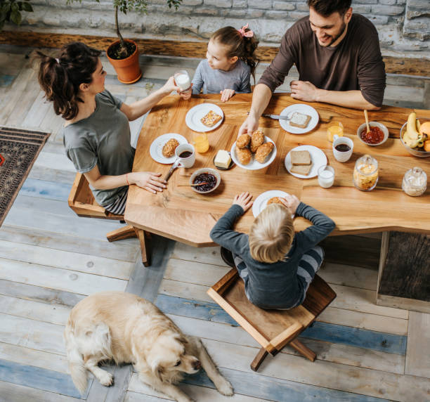 istock Above view of happy family talking during breakfast at dining table. 1072957638