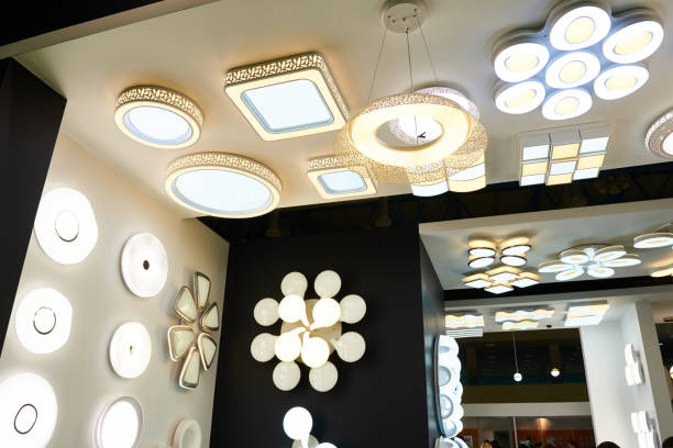 decorative ceiling lamps and chandeliers in store - light fixture imagens e fotografias de stock