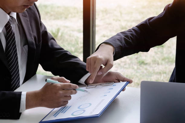 istock Businessman consult with finance document paper. 1072959078