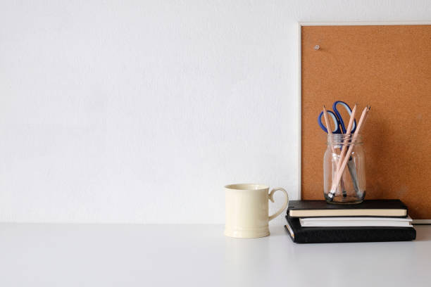 istock Coffee mug, notebook, pencil and office supplies with copy space on white table. 1072960858
