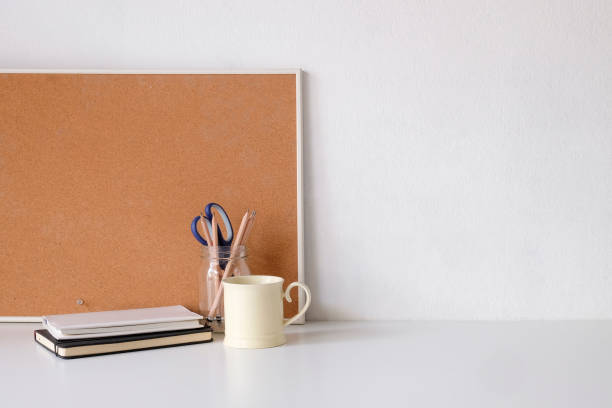 istock Coffee mug, notebook, pencil and office supplies with copy space on white table. 1072960960