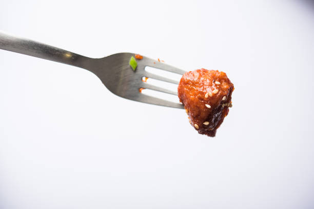 istock Indian Chilli Chicken dry, served in a plate over moody background. Selective focus 1072961550
