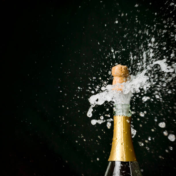 istock a champagne cork is popping out 1072961842