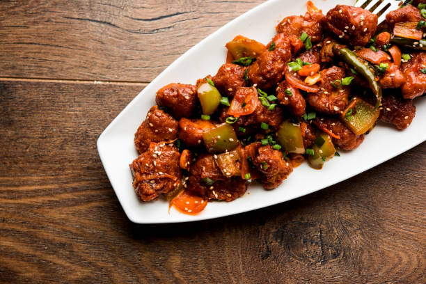 istock Indian Chilli Chicken dry, served in a plate over moody background. Selective focus 1072962414
