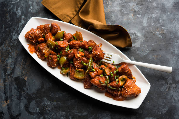istock Indian Chilli Chicken dry, served in a plate over moody background. Selective focus 1072962734