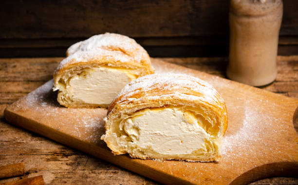 istock Vanilla cream roll pastry on a wooden table 1072962780