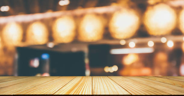 istock Empty Wood table top with Restaurant cafe or coffee shop interior with blur abstract vintage style bokeh light for montage product display background 1072963418