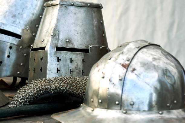 istock Steel medieval helmets with eyes slits on the table 1072970504