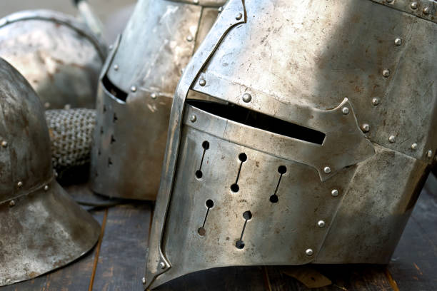 istock Steel medieval helmets with eyes slits on the table 1072970954