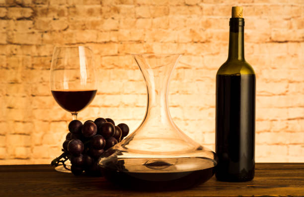 istock Glass with red wine and decanter on table 1072971034