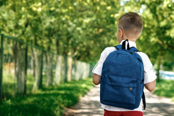 A little boy coming home from school