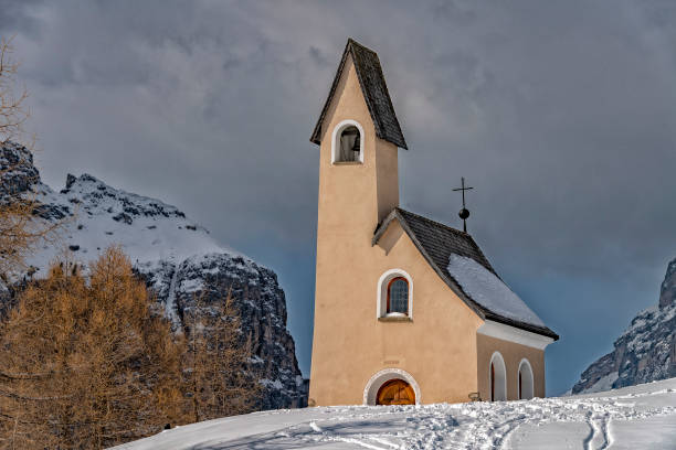istock Dolomites church view in winter snow time 1072981186