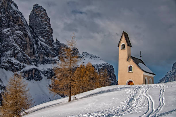 istock Dolomites church view in winter snow time 1072981196
