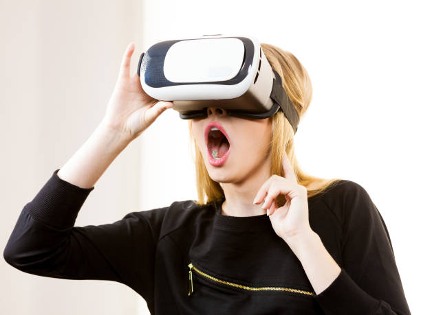 istock Woman wearing VR goggles 1072988832