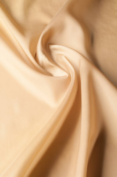 istock Texture background of fabric. Beige fabric. Silk fabric wallpaper texture background pattern in sepia pastel yellow cream beige tint: Lovely natural silk textured textile 1072991140