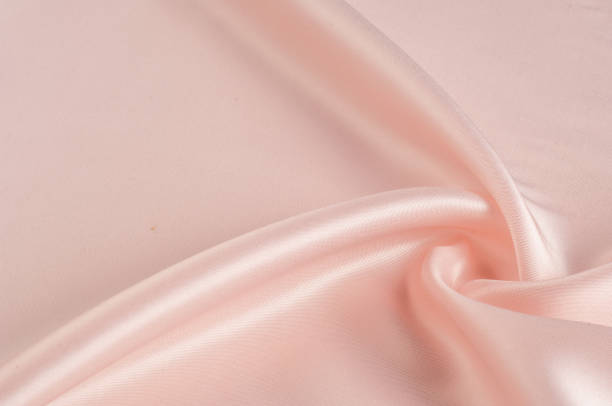 istock Texture, background, pattern. Fabric silk pink background. Beautiful pink satin. Drapery background. winds waves, creating a beautiful background of the folds. 1072991398