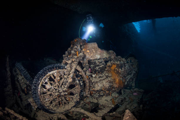 istock A rusted and overgrown motorcycle explored by a scuba diver inside a shipwreck under the sea 1072997394