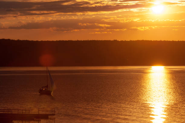 istock sunset on the water,  a boat in the sun 1072999066