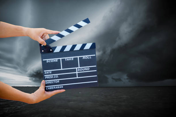 istock hand hold a Film Slate with storm cloud. 1073000406
