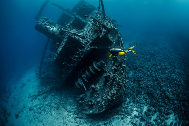 istock Scuba diver exploring a shipwreck under the Red Sea 1073000596