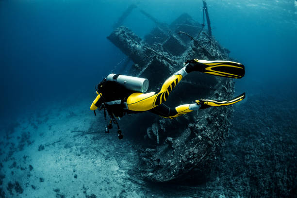 istock Scuba diver exploring a shipwreck under the Red Sea 1073001028