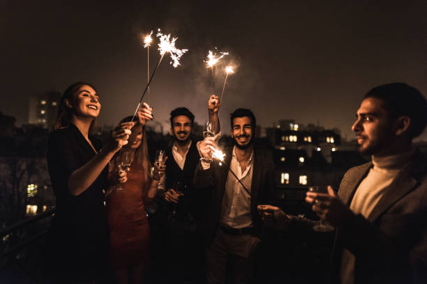 istock friends celebrate the new year on the rooftop 1073002016