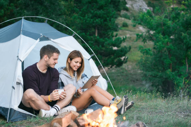 istock Happy Young Couple Using Digital Tablet In Camping Trip 1073002668