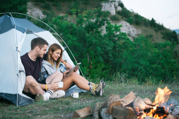 istock Happy Young Couple Using Digital Tablet In Camping Trip 1073003842