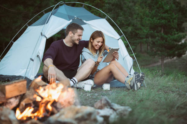 istock Happy Young Couple Using Digital Tablet In Camping Trip 1073003846