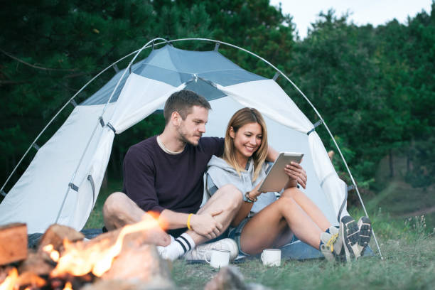 istock Happy Young Couple Using Digital Tablet In Camping Trip 1073003854