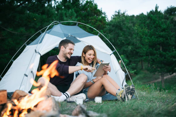 Happy Young Couple Using Digital Tablet In Camping Trip