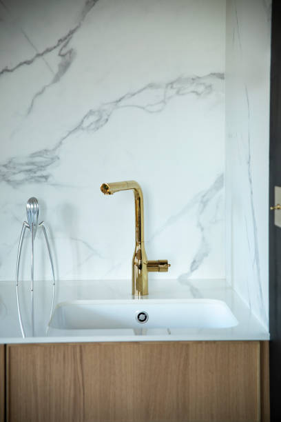 istock Modern and design scandinavian kitchen with accessories . Sunny and bright space with white marble wall. 1073003918