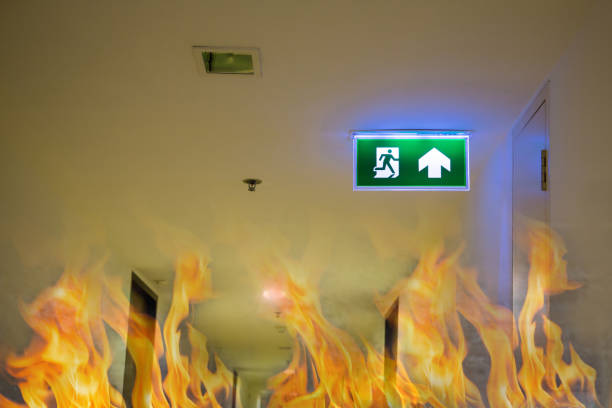 Green emergency exit sign showing the way to escape.Fire exit in the building.