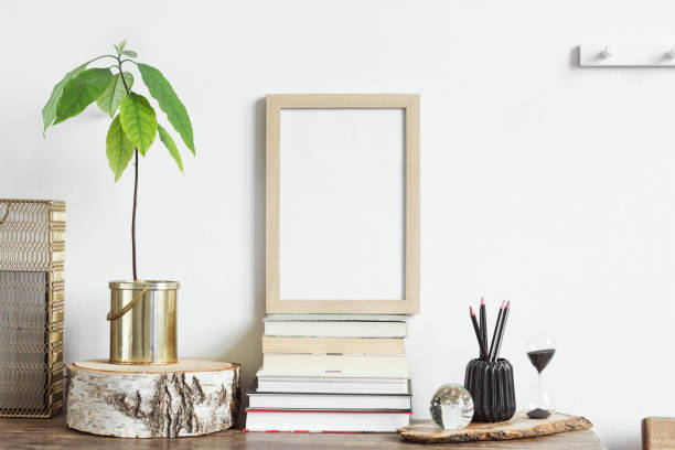 istock The stylish interior with mock up poster frame, plants, books and notebook. The retro concept of space. 1073005288