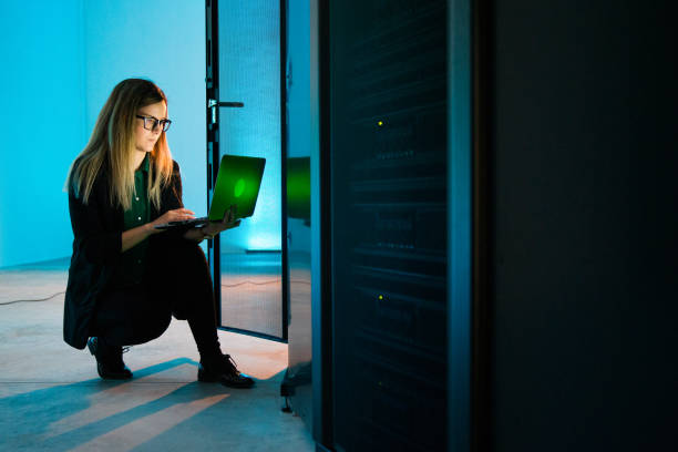 istock Young Female IT Professional Connecting to Supercomputer WIth Laptop 1073008976
