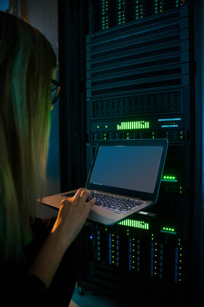 istock Young Female IT Professional Connecting to Supercomputer WIth Laptop 1073008986