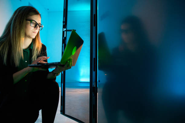 istock Female IT Professional Working With Laptop in Supercomputer Room 1073008988