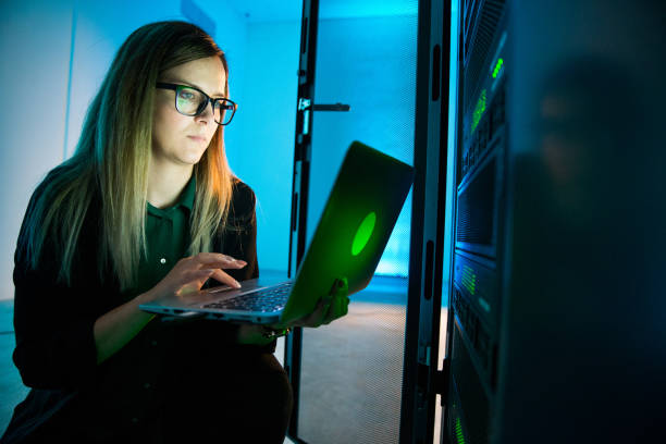 istock Female IT Professional Working With Laptop in Supercomputer Room 1073009018