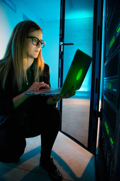 istock Female IT Professional Working With Laptop in Supercomputer Room 1073009048