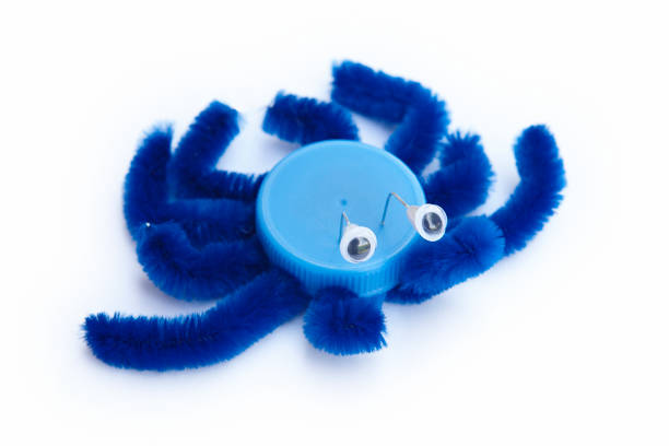 istock Plastic bottle cap recycled in a crab figure. Reuse garbage 1073009118