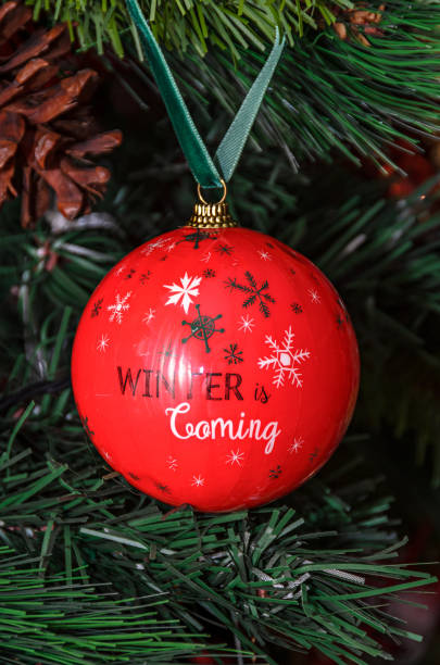 istock Christmas tree hanging ornament, red globe with write winter is coming, close up 1073015766