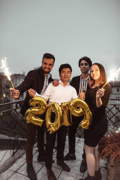 istock friends celebrate the new year on the rooftop 1073017002