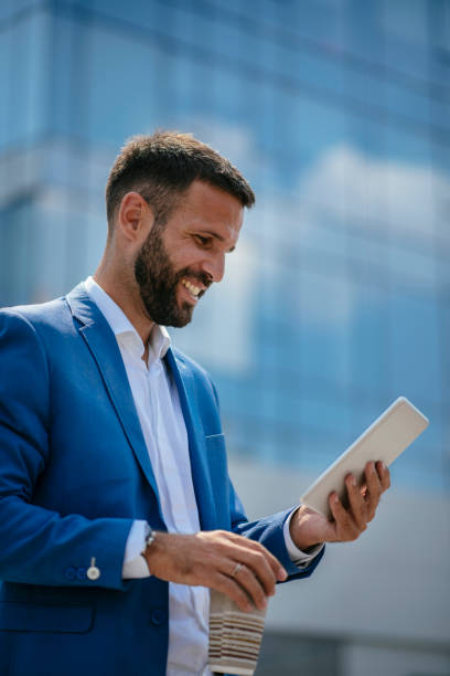 istock Businessman working on digital tablet on a coffee break 1073017630