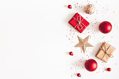 Christmas composition. Christmas gifts, red and golden decorations on white background. Flat lay, top view, copy space