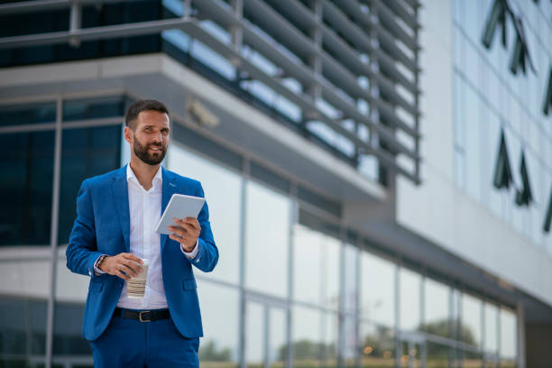 istock Businessman working on digital tablet on a coffee break 1073019440
