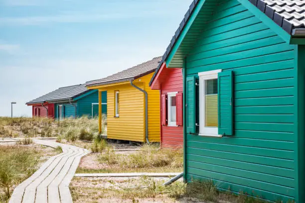 Colorful wooden houses on the beach in the dunes