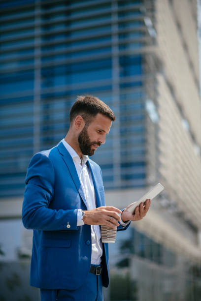 istock Businessman working on digital tablet on a coffee break 1073021712